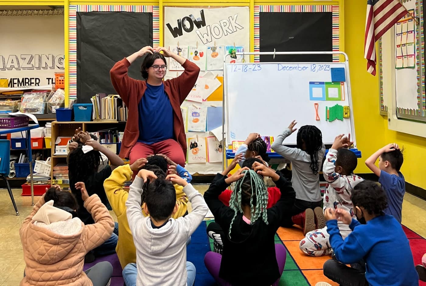 A Poet in Residence teaches a group of students in the classroom