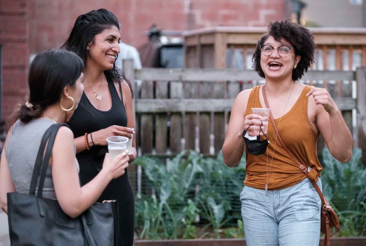 Poets chatting and smiling at Blatant Gold summer gathering.